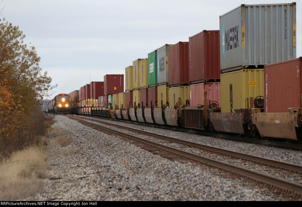 Westbound grain loads approach on Track 1 as eastbound stacks pass on 2